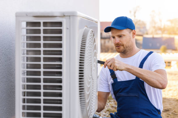 HVAC technician servicing an outdoor air conditioner in Pleasanton
